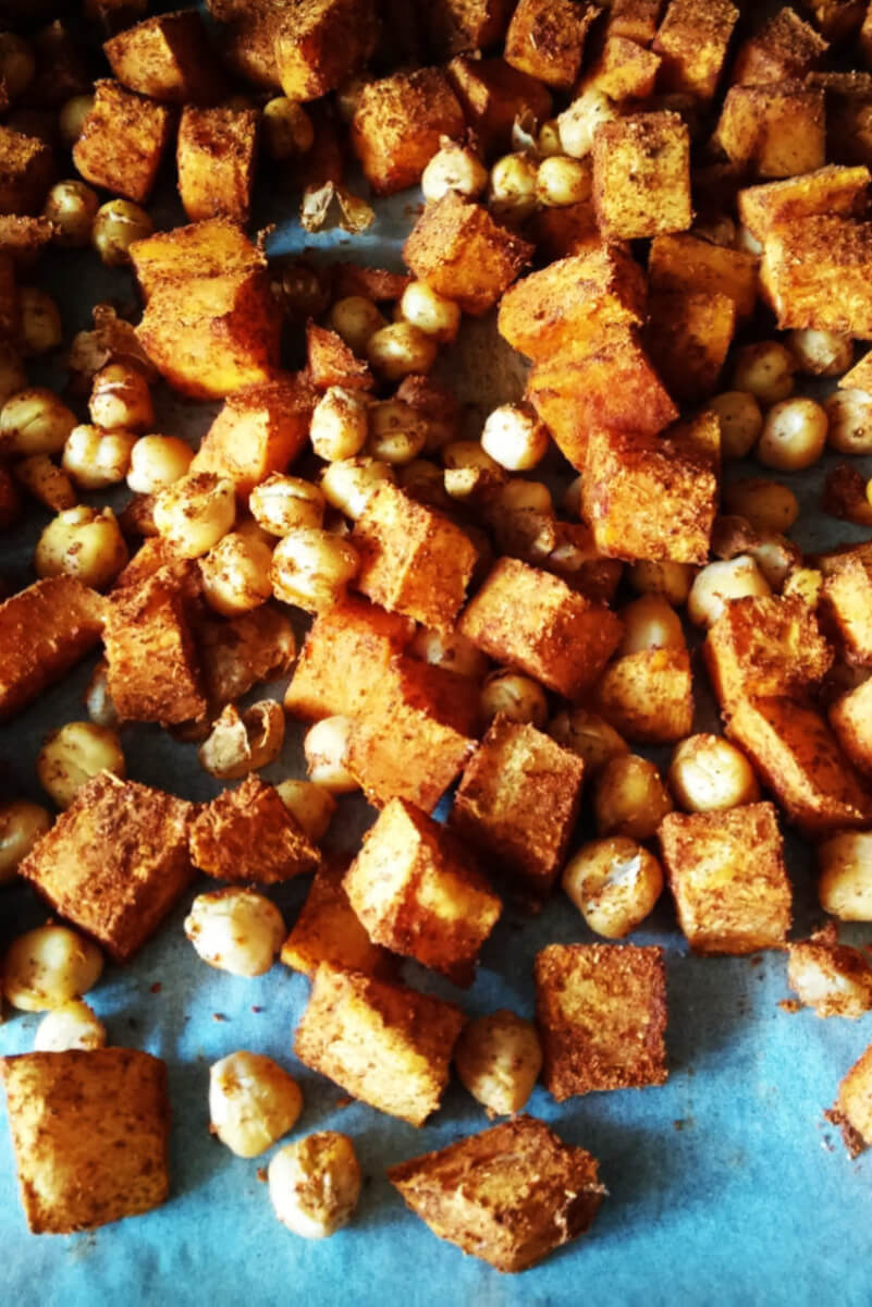 Salad with roasted sweet potatoes, chickpeas, dried tomatoes, hummus and kale