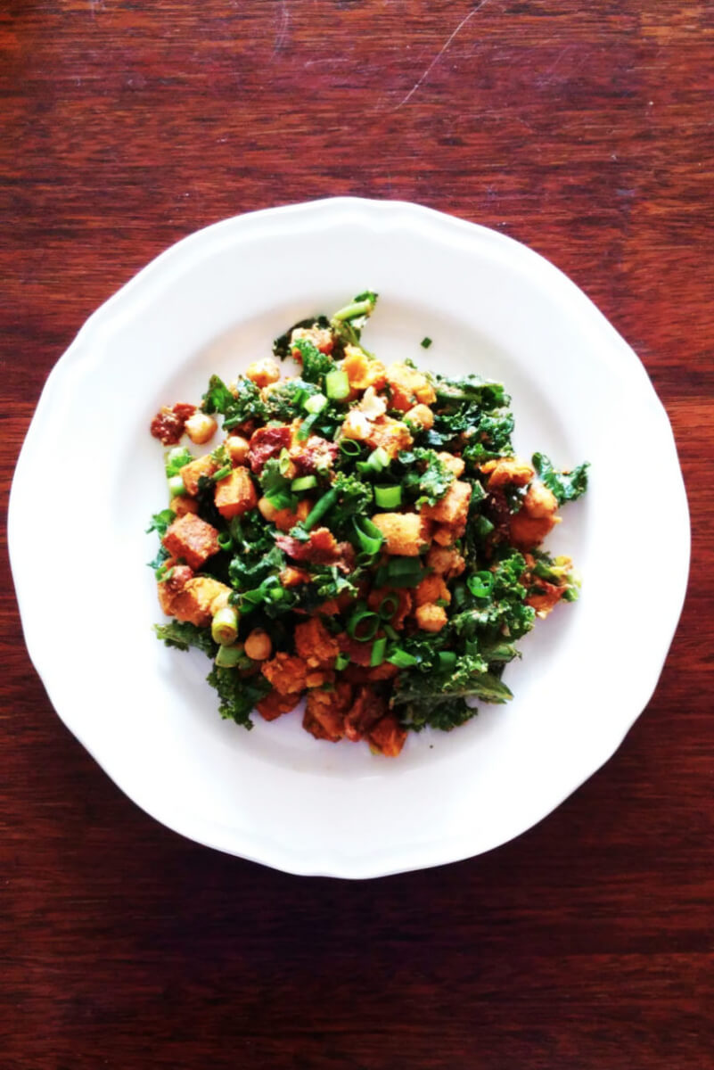 Salad with roasted sweet potatoes, chickpeas, dried tomatoes, hummus and kale