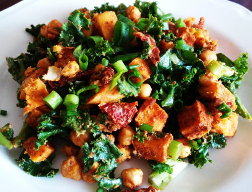 Salad with roasted sweet potatoes, chickpeas, dried tomatoes, hummus and kale